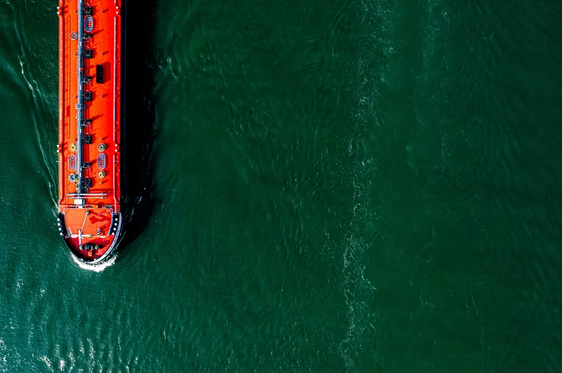Aerial view of cargo ship on waterway — global logistics